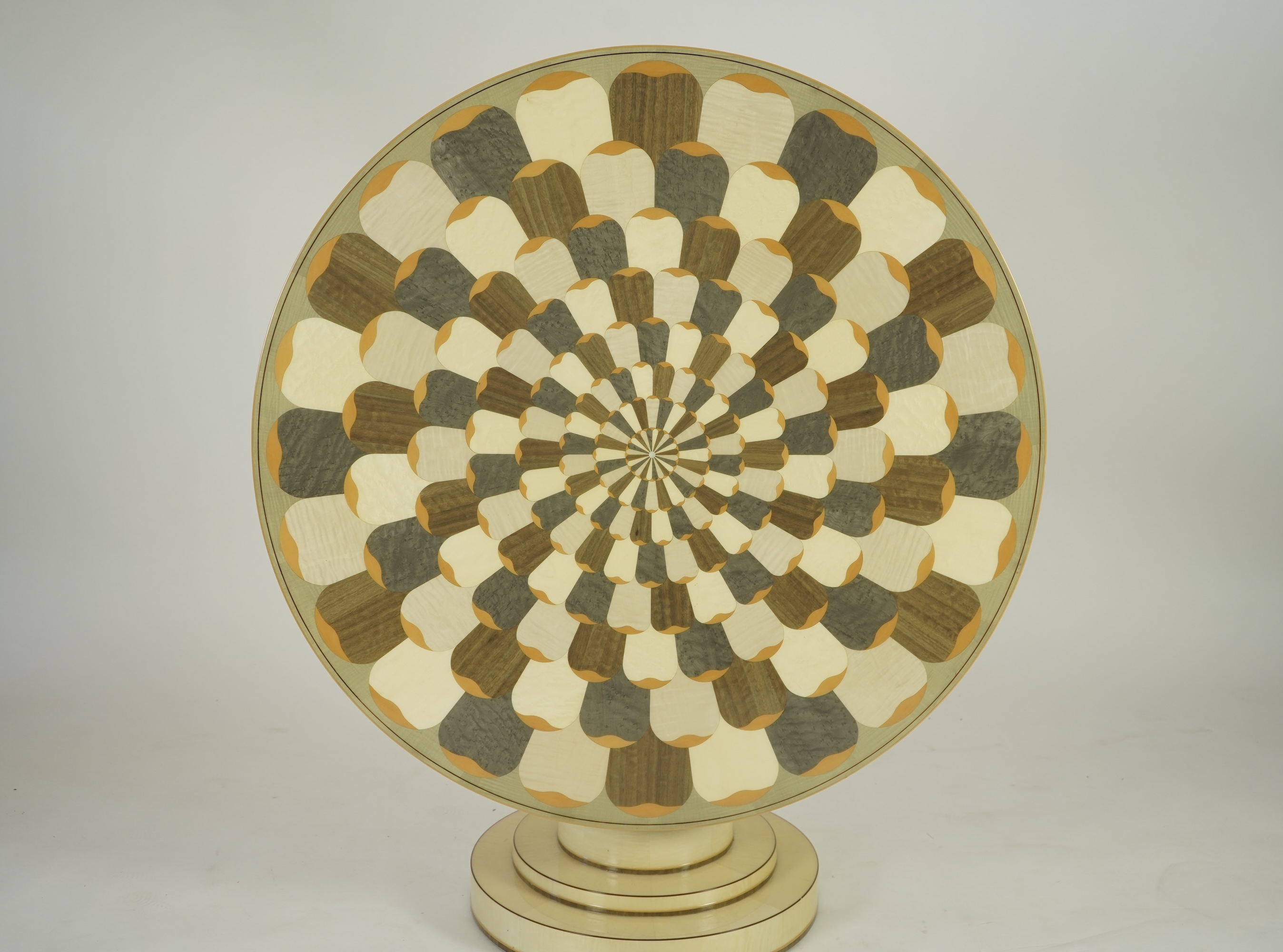 Lignae: A contemporary chrysanthemum and specimen wood inlaid circular tilt top centre table